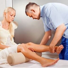 Doctor examining a patient's knee joint